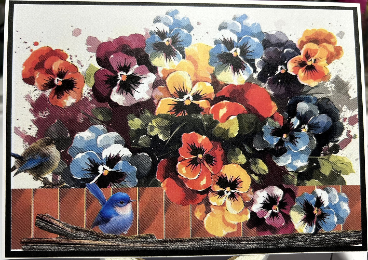 Colourful pansy flowers with birds on a wooden fence